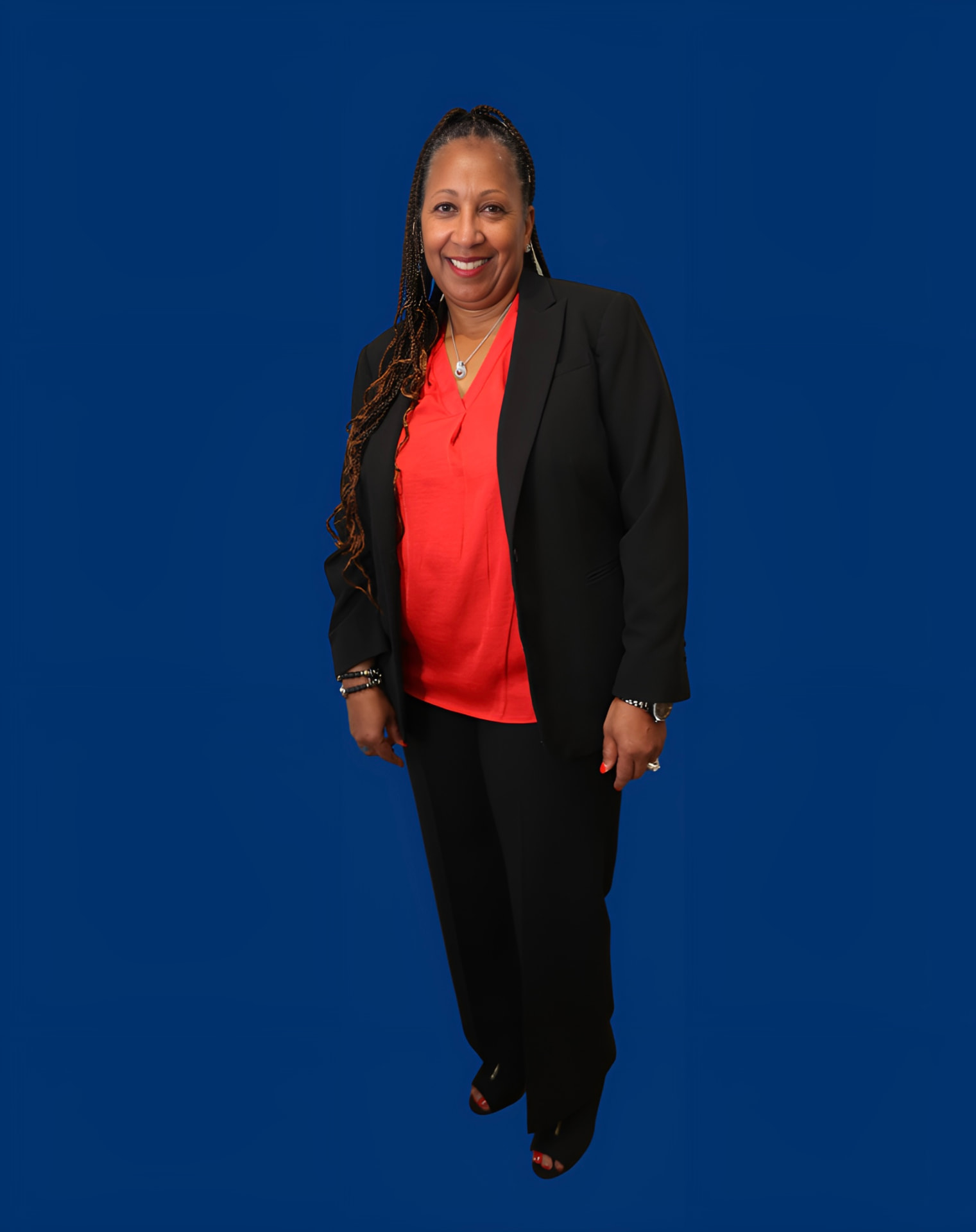Tonya Baker wearing a red shirt and black blazer